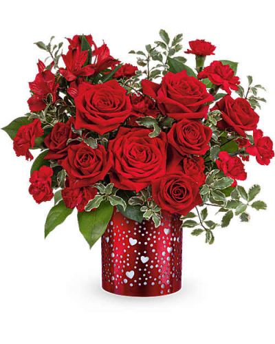 Let your love shine with Teleflora's I Heart You Bouquet, featuring a passionate mix of red roses, alstroemeria, and carnations arranged in a red metal lantern adorned with charming heart and dot cutouts-a heartfelt Valentine's Day keepsake.