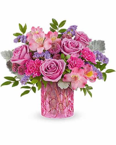 Celebrate her in style with Teleflora's Pink Rhapsody Bouquet, a vibrant mix of pink and lavender blooms beautifully arranged in Teleflora's Pink Rhapsody Vase. This stunning Mother's Day gift adds bold color and lasting charm to any space.
Teleflora's Pink Rhapsody Bouquet is a vibrant Mother's Day flower arrangement featuring lavender roses, pink alstroemeria, fuchsia carnations, purple button spray chrysanthemums, and lavender sinuata statice, accented with dusty miller and huckleberry, delivered in Teleflora's Pink Rhapsody Vase.